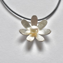 Domed daisy and pearl necklace on leather cord