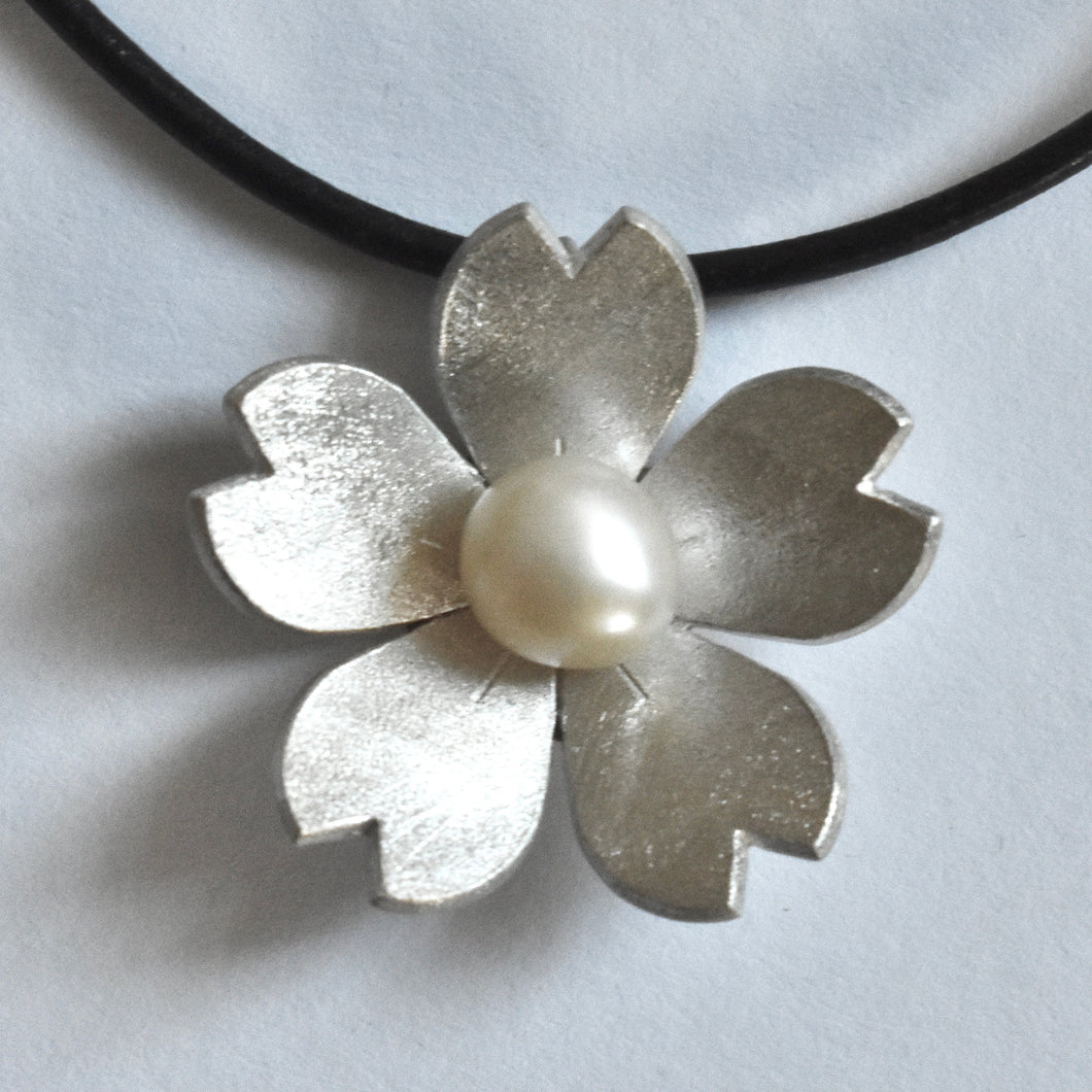 Domed sakura and pearl necklace on leather cord