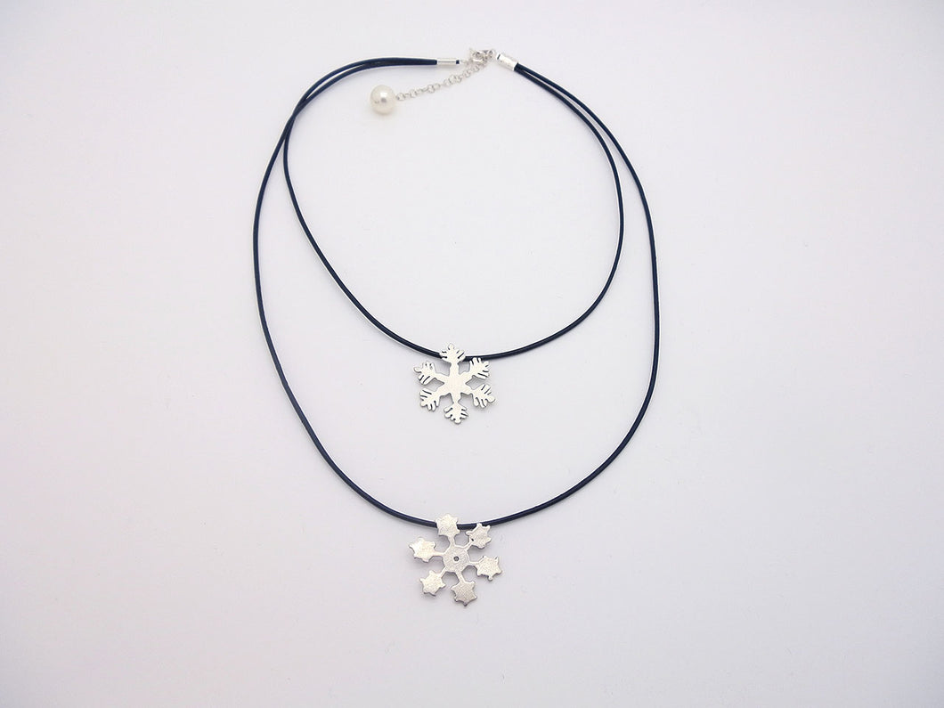 Handmade Snowflakes Hanging On Black Leather Cord Of Two Layers With A Pearl